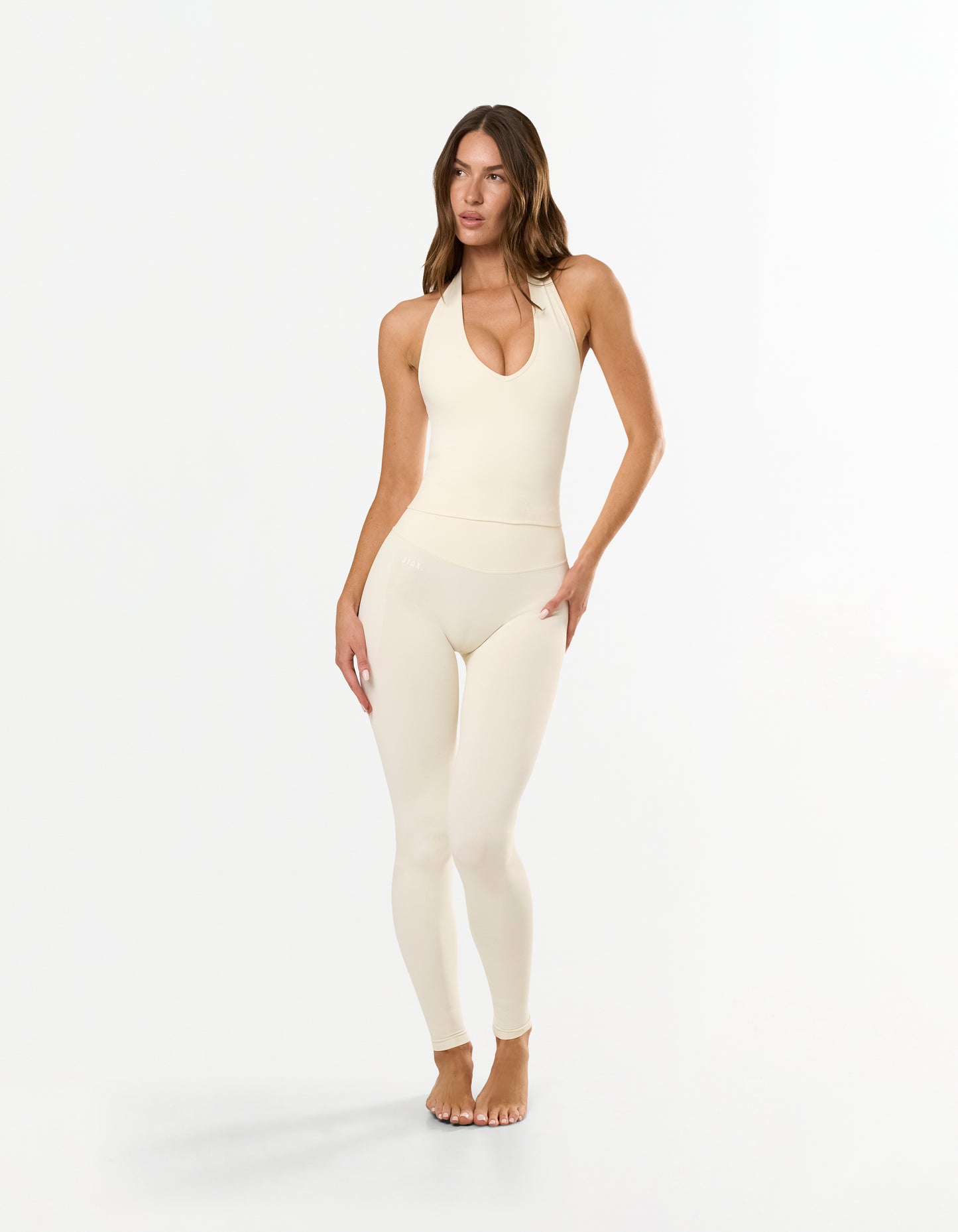 Front view of STAX. V Premium Seamless Skulpt Halter Tank in Cream showing flattering compressive fit