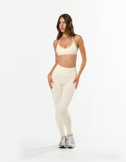 Front view of STAX. Premium Seamless Skulpt Bralette in Cream showing sculpting compressive fit with matching tights