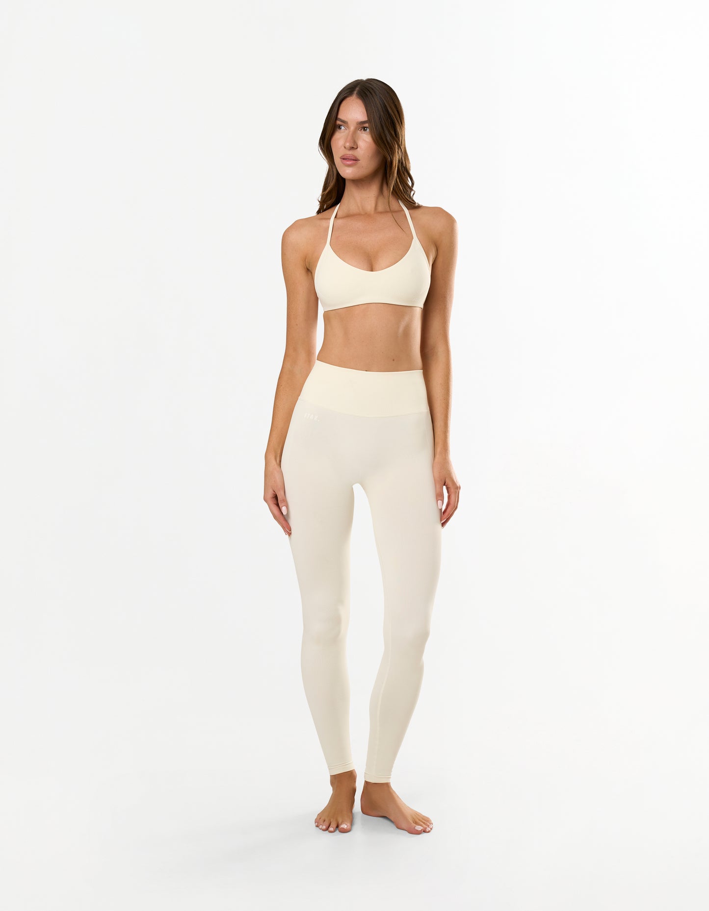 Front profile of STAX. Premium Seamless Skulpt Bralette in Cream showing Strappy halter neck design