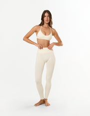 Front view of model wearing STAX. Premium Seamless Skulpt Leggings in Cream with matching skulpt bralette in Cream