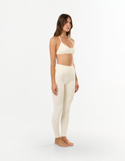 Side profile of model wearing STAX. Premium Seamless Skulpt Leggings in Cream emphasising secure sculpted silhouette 
