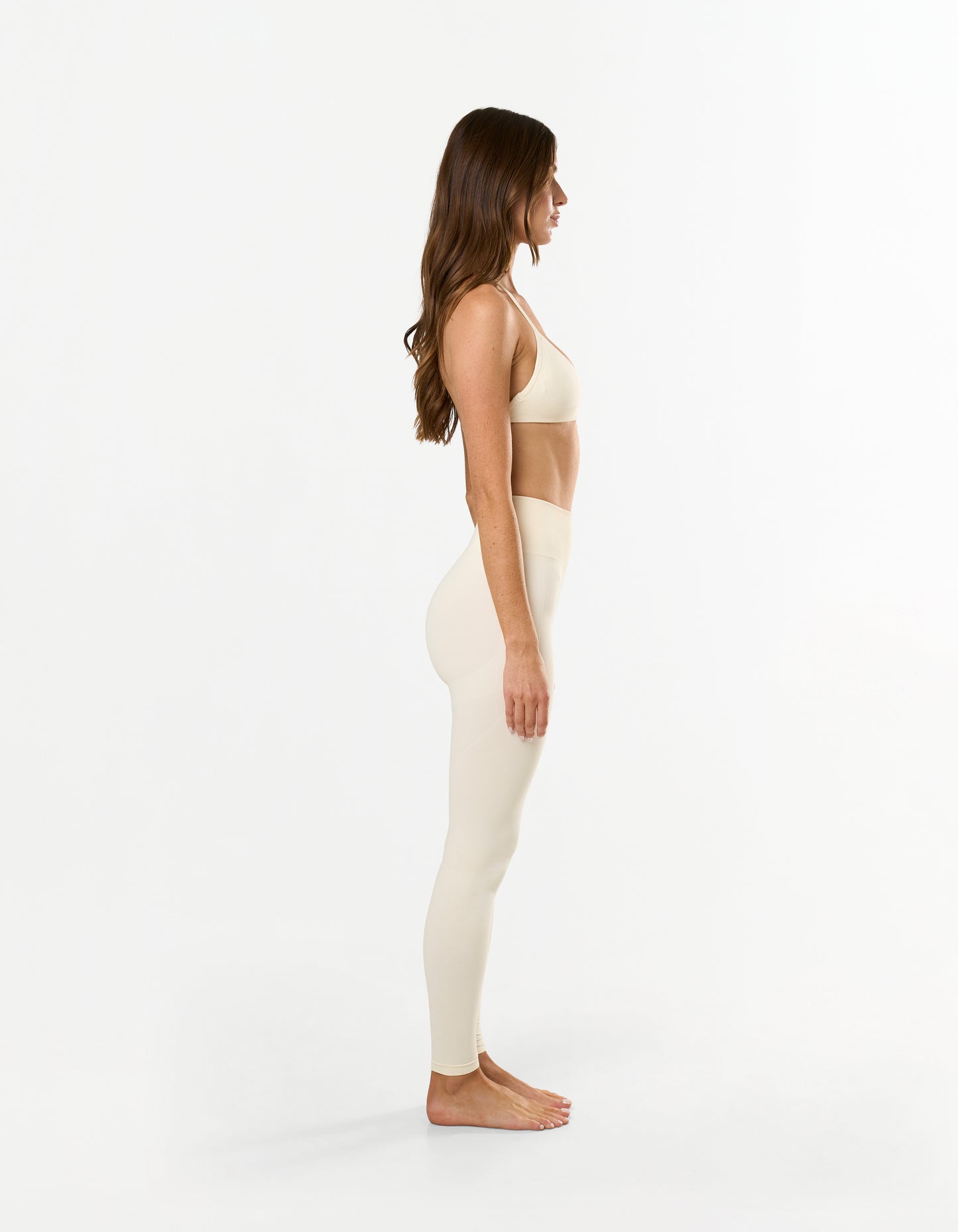 Side view of model wearing STAX. Premium Seamless Skulpt Bralette in Cream - light support sculpting design