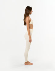 Side view of model wearing STAX. Premium Seamless Skulpt Bralette in Cream - light support sculpting design