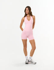 Front view of model wearing STAX. Premium Seamless Skulpt Midi Bike Shorts in Pink with matching skulpt halter neck tank