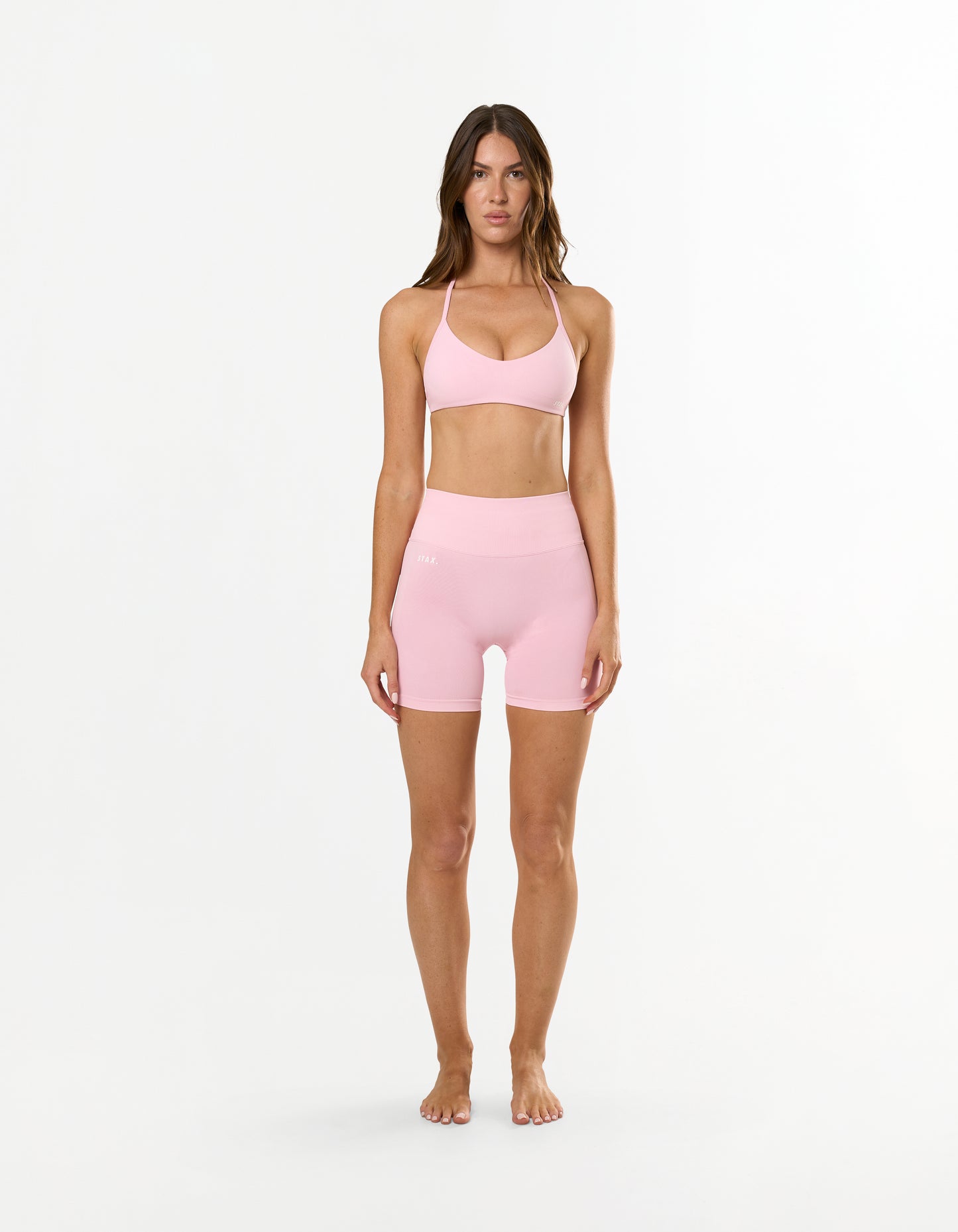 Front view of model wearing STAX. Premium Seamless Skulpt Bralette in Pink with removable padding 