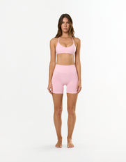 Front view of model wearing STAX. Premium Seamless Skulpt Bralette in Pink with removable padding 