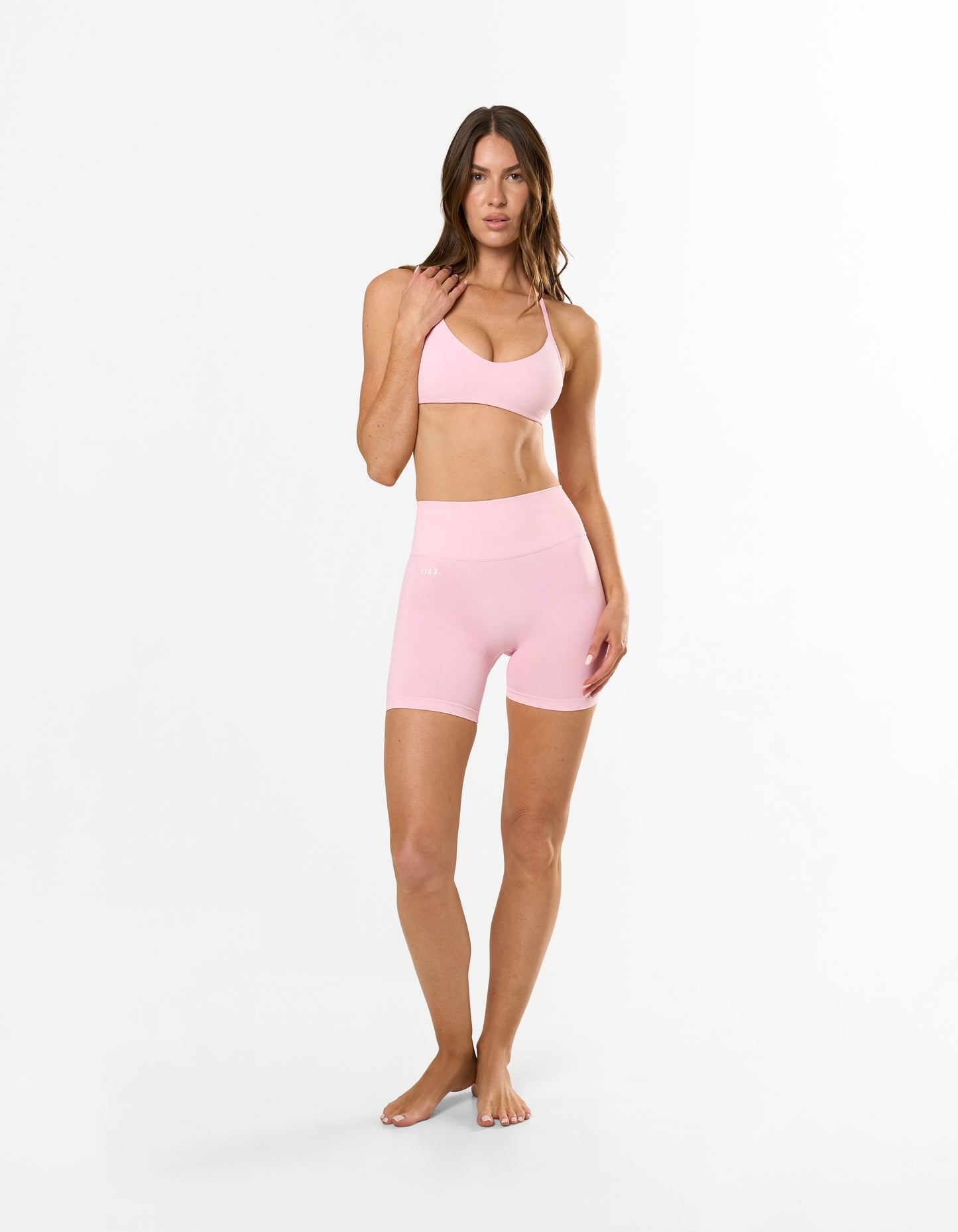 Front profile of STAX. Premium Seamless Skulpt Bralette in Pink showing Strappy halter neck design