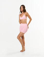 Front view of model wearing STAX. Premium Seamless Skulpt Bralette in Pink - light support sculpting design