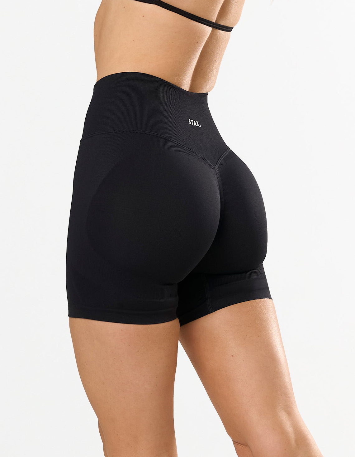 STAX. Premium Seamless Skulpt Midi Bike Shorts in Black - Compressive Fit - Skulpt Tights showing flattering invisible scrunch detail 