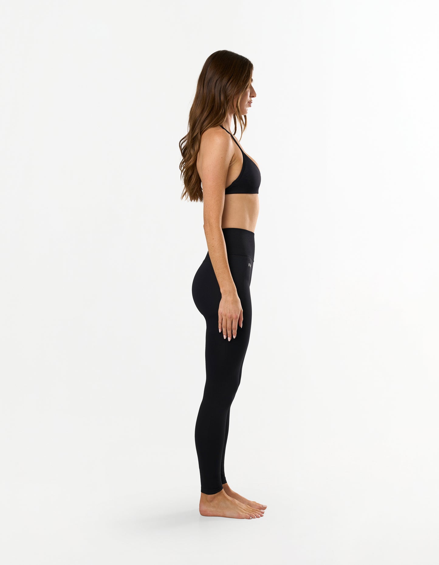 Side profile of STAX. Premium Seamless Skulpt Bralette in Black showing figure hugging and compressive stretch fabric design