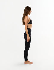Side profile of STAX. Premium Seamless Skulpt Bralette in Black showing figure hugging and compressive stretch fabric design