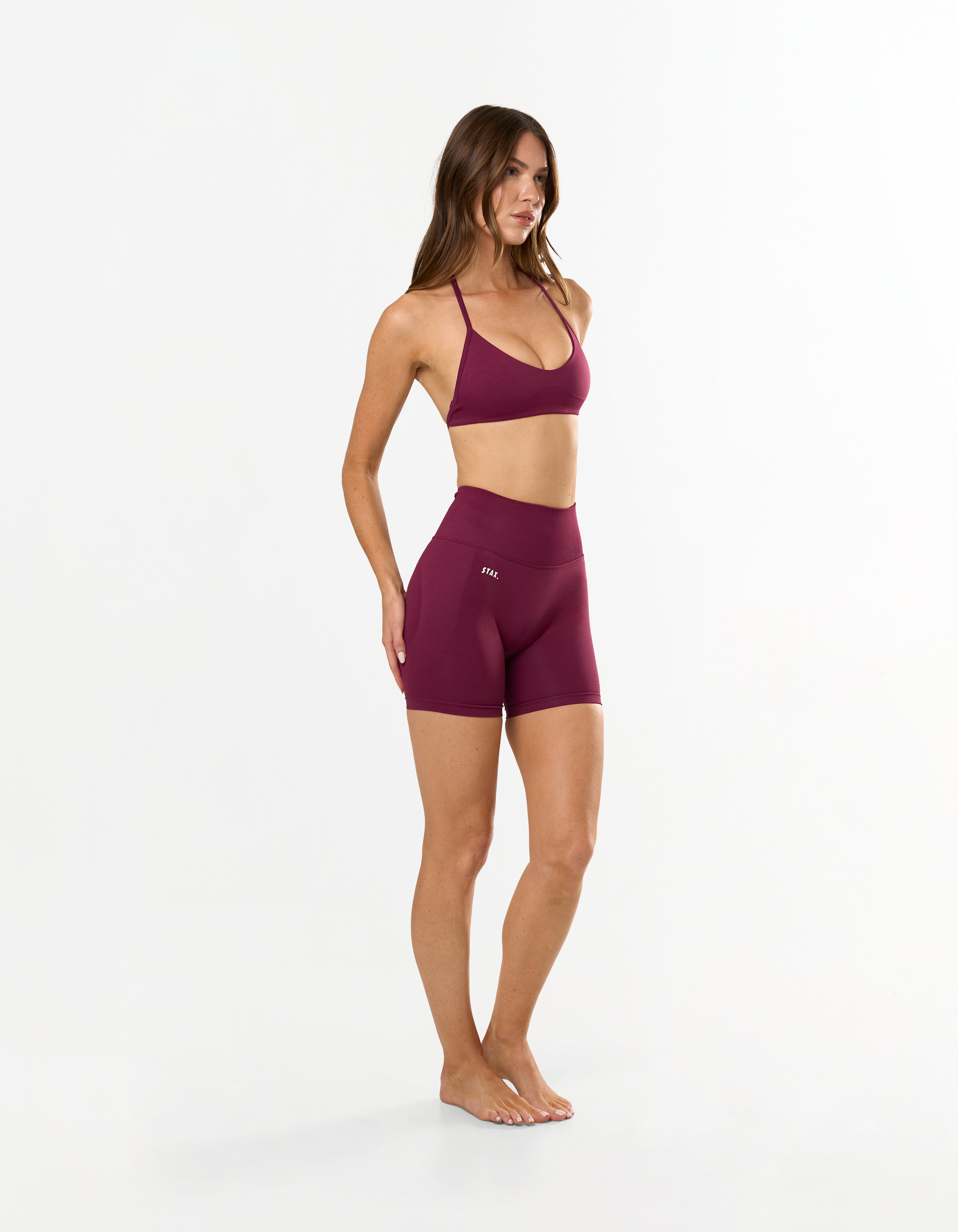 Front profile of STAX. Premium Seamless Skulpt Bralette in Burgundy with light support showing flattering strappy halter neck design