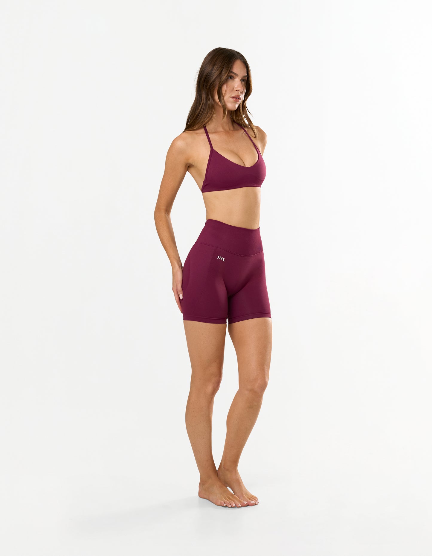 Front profile of STAX. Premium Seamless Skulpt Bralette in Burgundy with light support showing flattering strappy halter neck design