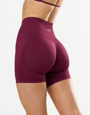 STAX. Premium Seamless Skulpt Midi Bike Shorts in Burgundy - Compressive Fit - Skulpt Tights showing flattering invisible scrunch detail 