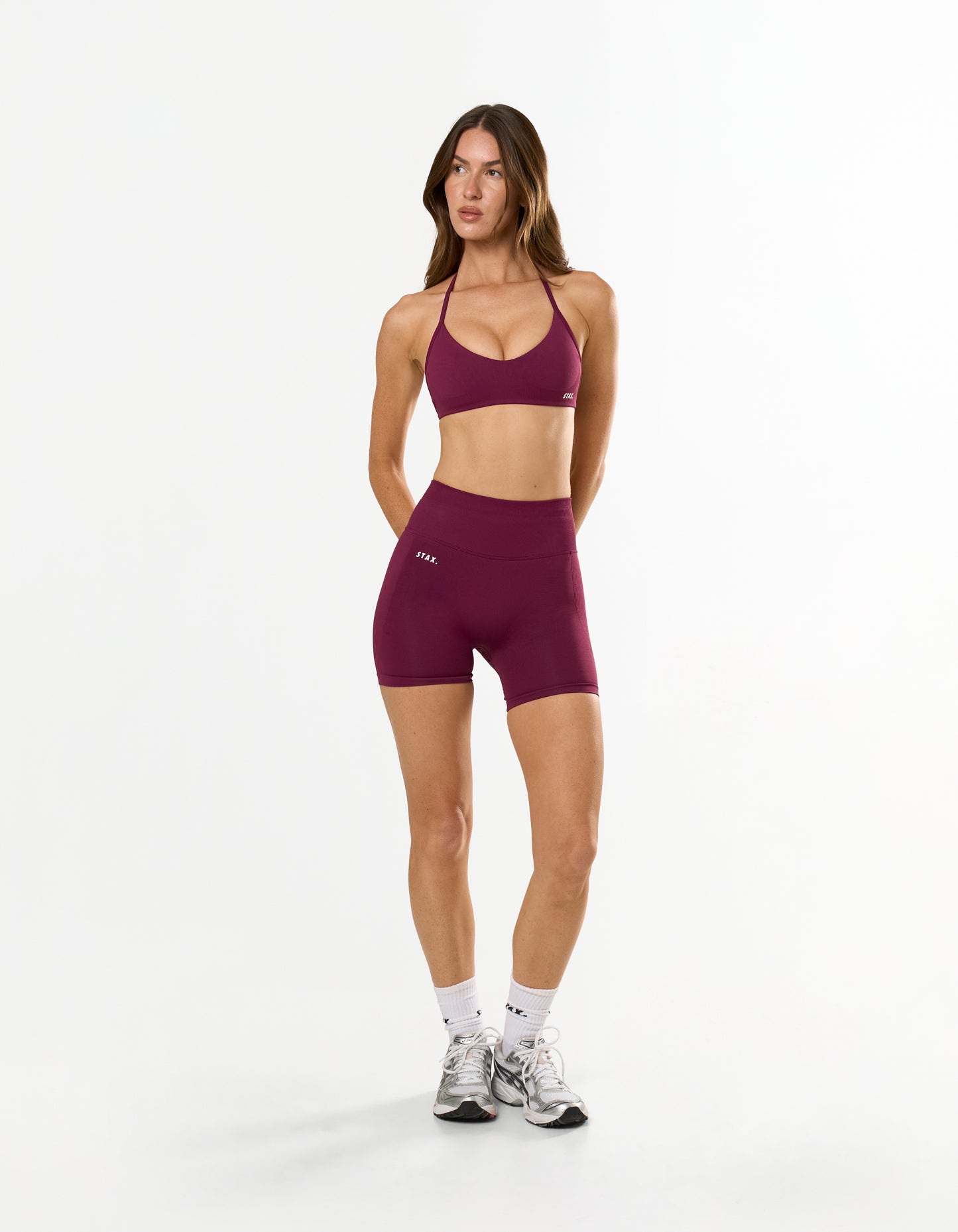 Front view of model wearing STAX. Premium Seamless Skulpt Midi Bike Shorts   and matching strappy halter neck bralette