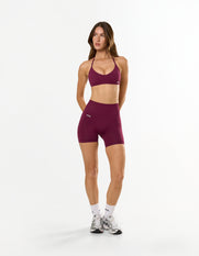 Front view of model wearing STAX. Premium Seamless Skulpt Midi Bike Shorts   and matching strappy halter neck bralette