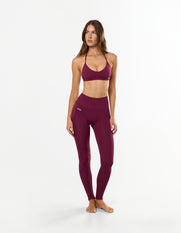 Front profile of STAX. Premium Seamless Skulpt Bralette in Burgundy with compressive fit and strappy halter neck design