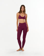 Front view of model wearing STAX. Premium Seamless Skulpt Bralette in Burgundy with matching Premium Seamless Skulpt Full Length Tights