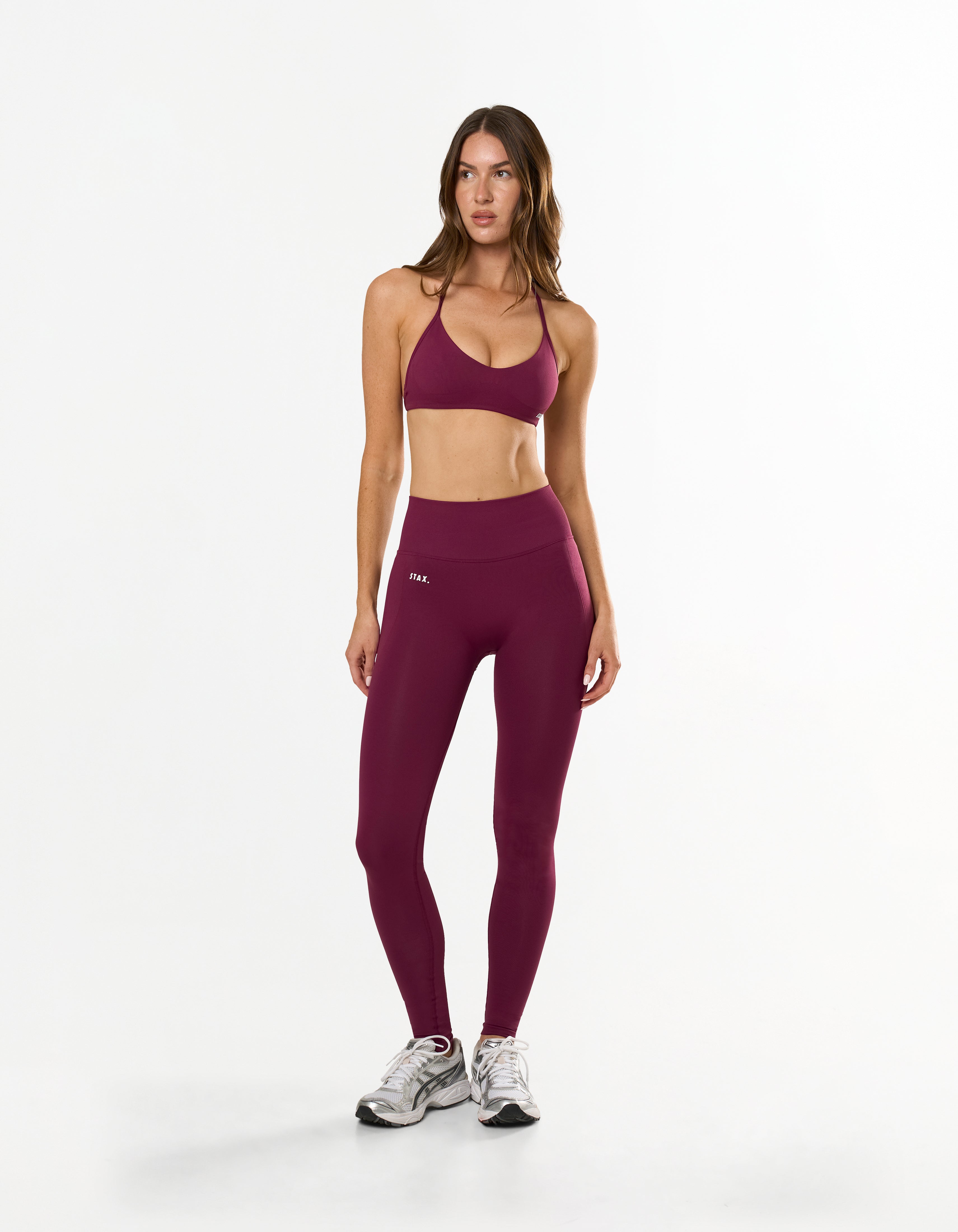 Front view of model wearing STAX. Premium Seamless Skulpt Tights in Burgundy with matching skulpt bralette