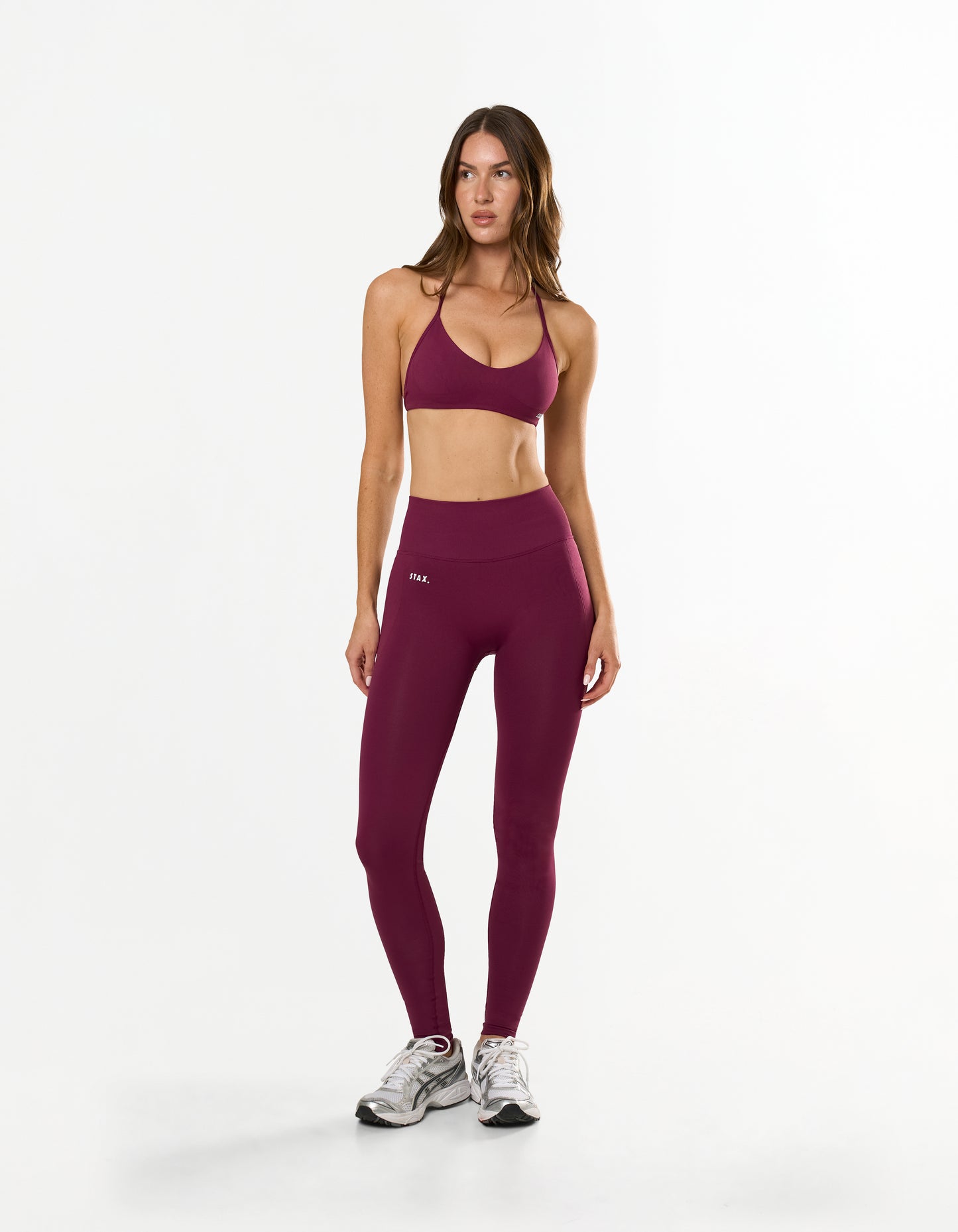 Front view of model wearing STAX. Premium Seamless Skulpt Tights in Burgundy with matching skulpt bralette