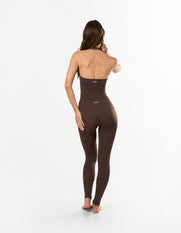 Back view of model wearing STAX. Premium Seamless Skulpt Halter Tank in Brown with halter neck design with ribbed waist panel 