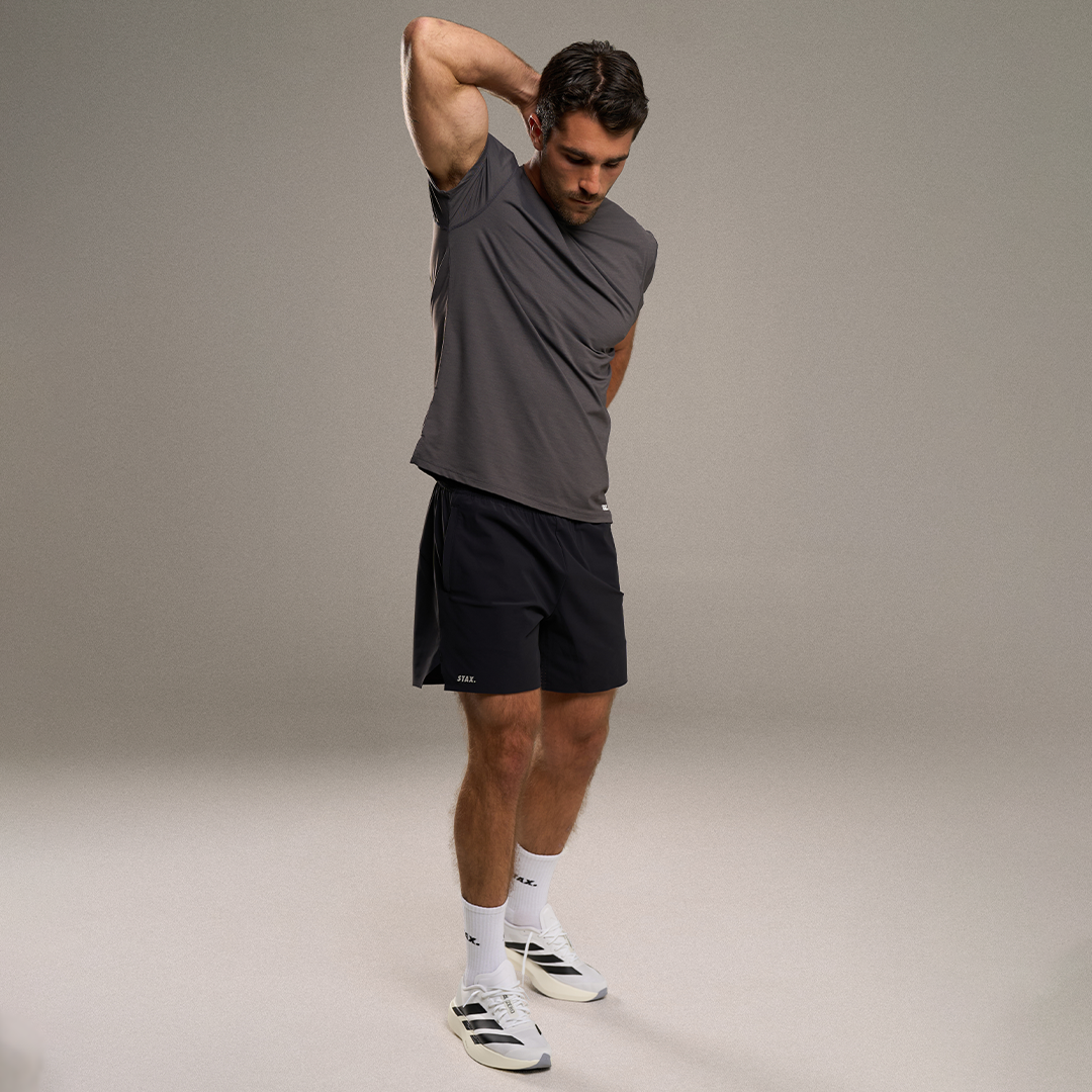 STAX. Mens Sport Collection - Male model lifting weights in gym - Performance tees and shorts 