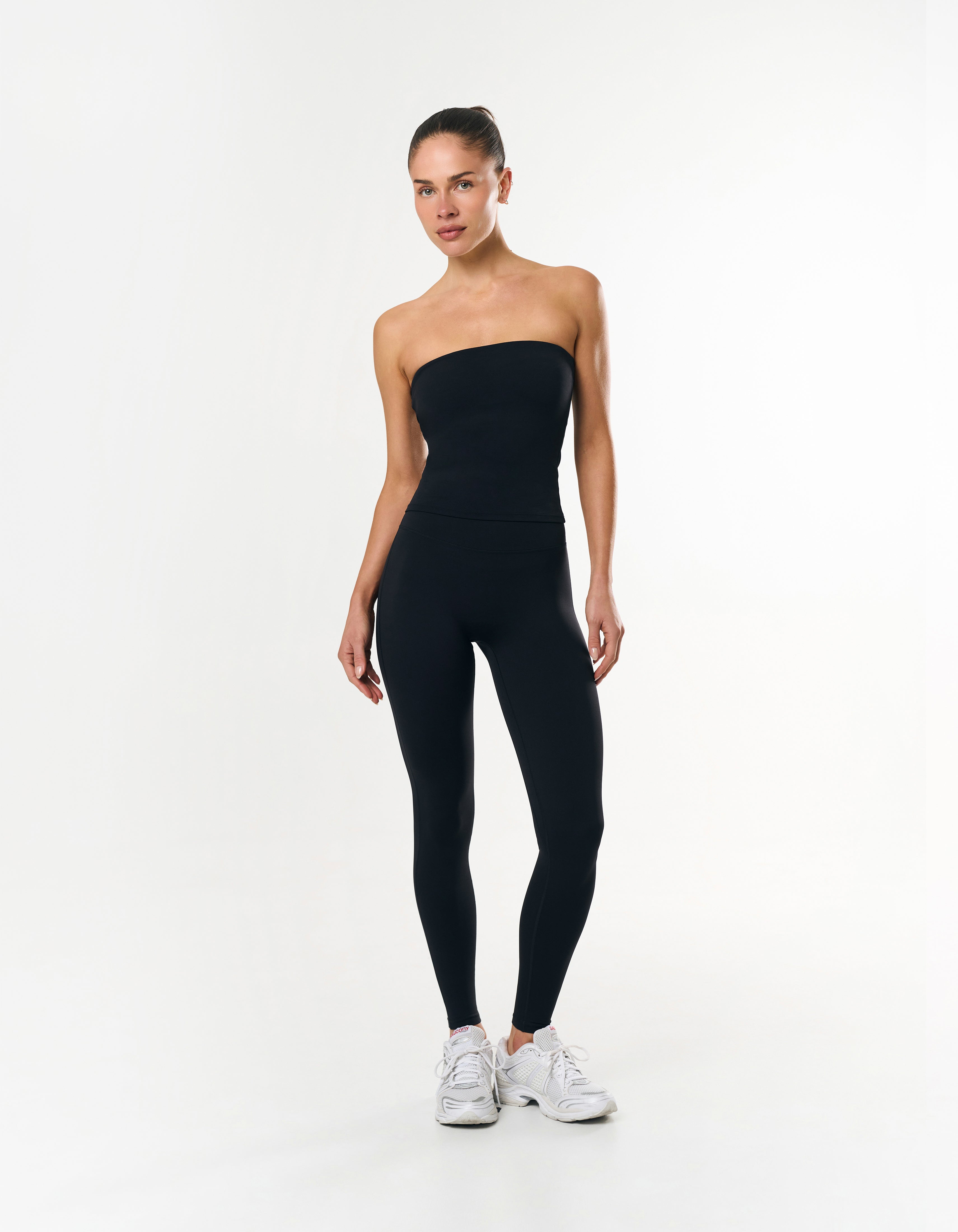 Front view of model wearing STAX. Full Length Tights Airlyte in Black with matching bandeau top airlyte in black
