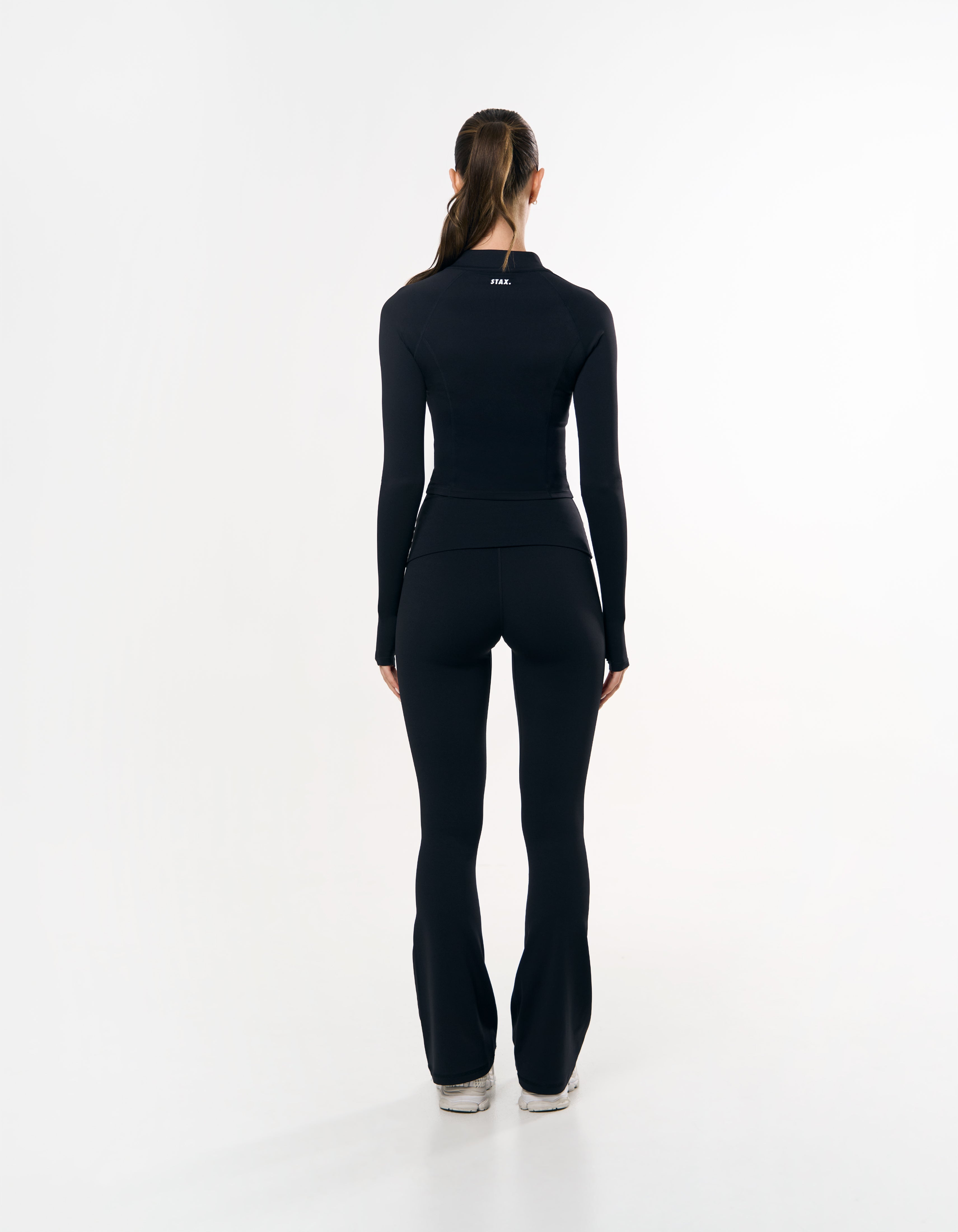 Back view of STAX. Fold Over Flares in black emphasising high waist flattering fit