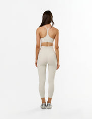 Back view of STAX. NFS 7/8 Tights NANDEX™ in Oat showing flattering fit and matching strappy crop with racerback design 
