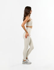 Side profile of STAX. NFS Full Length Tights NANDEX™ in Oat showing flattering high waisted design