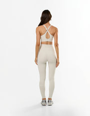 Back view of STAX. NFS Full Length Tights NANDEX™ in Oat showing small white logo and matching high support sports bra