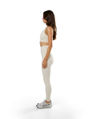 Side view of model wearing STAX. Adapt Crop NANDEX™ in Oat with removable padding 