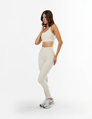 Front view of model wearing STAX. NFS Full Length Tights NANDEX™ in Oat with high waist supportive and flattering fit
