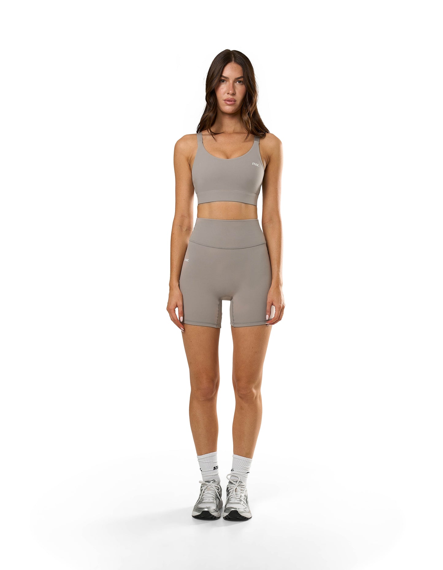 Front view of STAX. NFS Midi Bike Shorts NANDEX™ in Taupe showing flattering high waist fit and matching sports bra