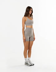 Side profile of STAX. NFS Midi Bike Shorts NANDEX™ in Taupe showing flattering high waist fit 