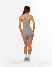 Back view of STAX. Adapt Crop NANDEX™ in Taupe showing cross cross back strap design 
