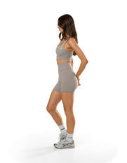 Side view of STAX. Adapt Crop NANDEX™ in Taupe with matching NFS Midi Bike Shorts NANDEX™