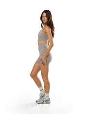 Side profile of STAX. NFS Midi Bike Shorts NANDEX™ in Taupe showing waist support to accentuate your shape  