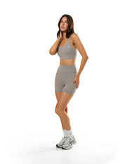 Front view of model wearing STAX. NFS Midi Bike Shorts NANDEX™ in Taupe  with matching Adapt Crop NANDEX™