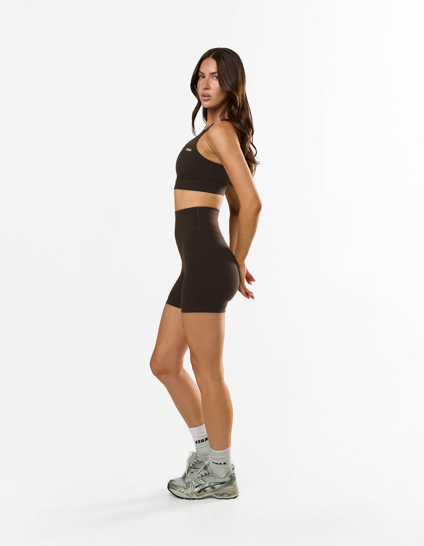 Side profile of model wearing STAX. NFS (No Front Seam) Midi Bike Shorts NANDEX™ in Espresso with matching Adapt crop NANDEX™