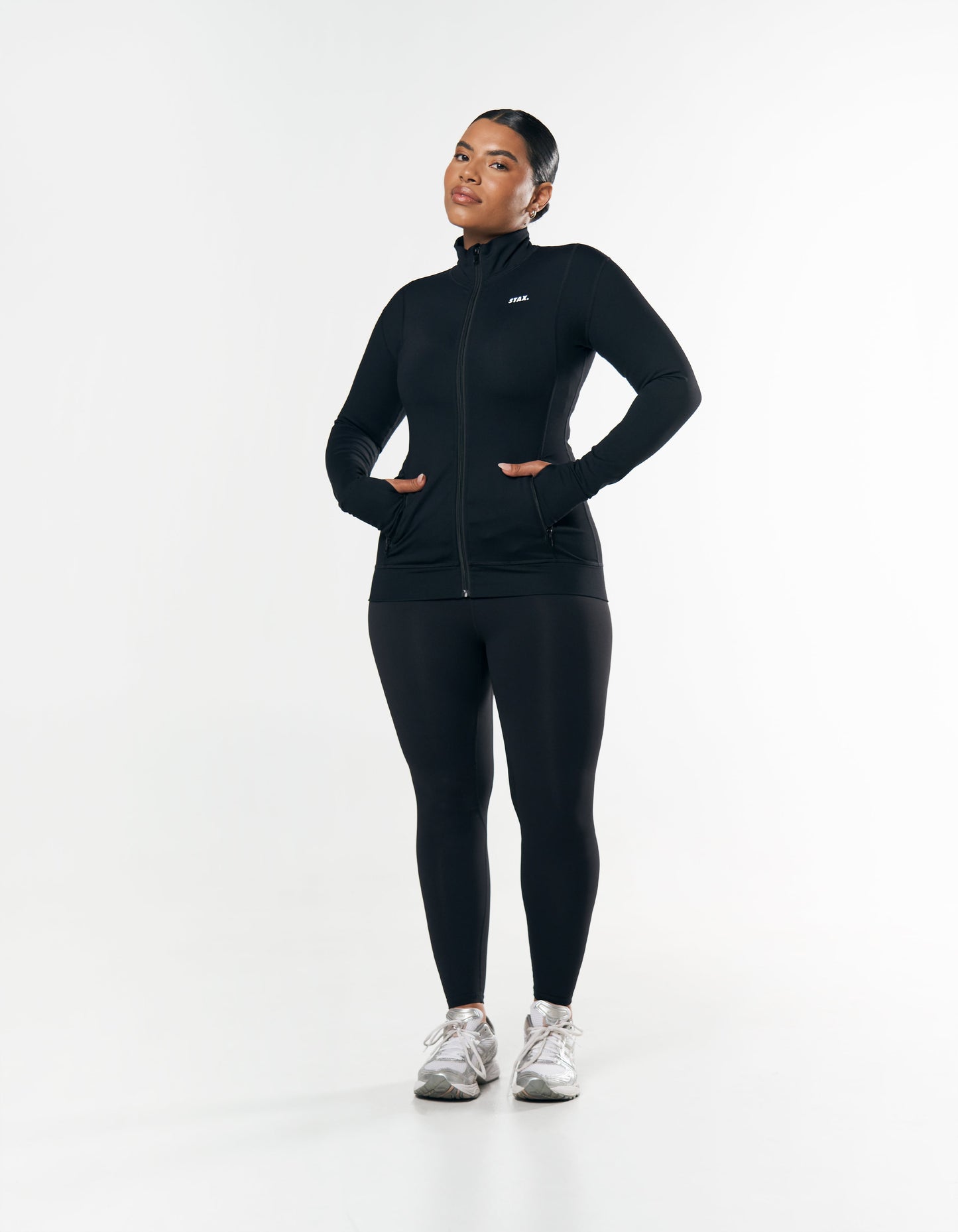 Front view of curve model wearing STAX. Zip Jacket NANDEX™ in Black with matching Full Length Tights NANDEX™ Original in Black