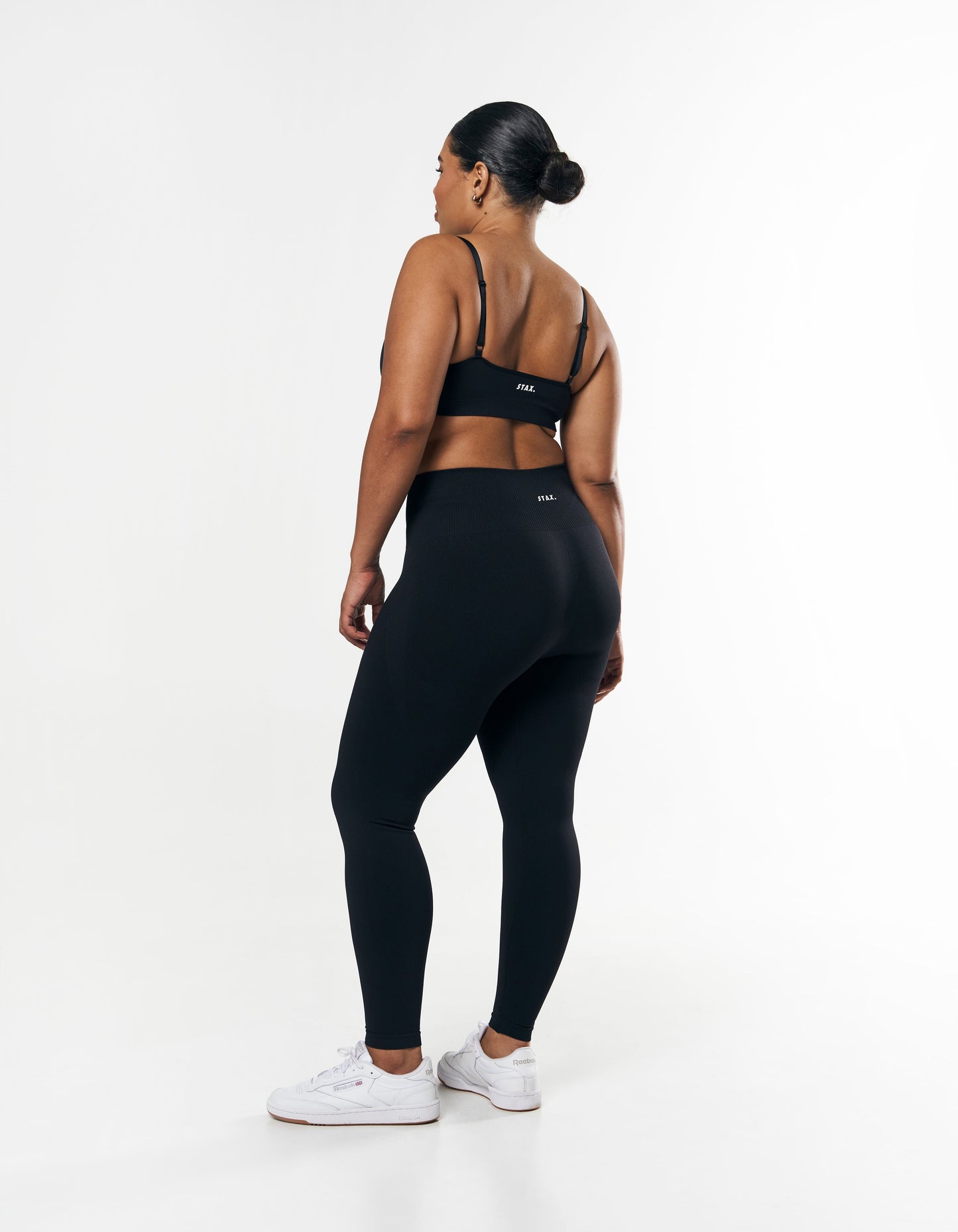 Front view of model wearing STAX. Premium Seamless Tights in Astro showing STAX. white logo