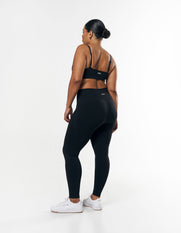 Front view of model wearing STAX. Premium Seamless Tights in Astro showing STAX. white logo