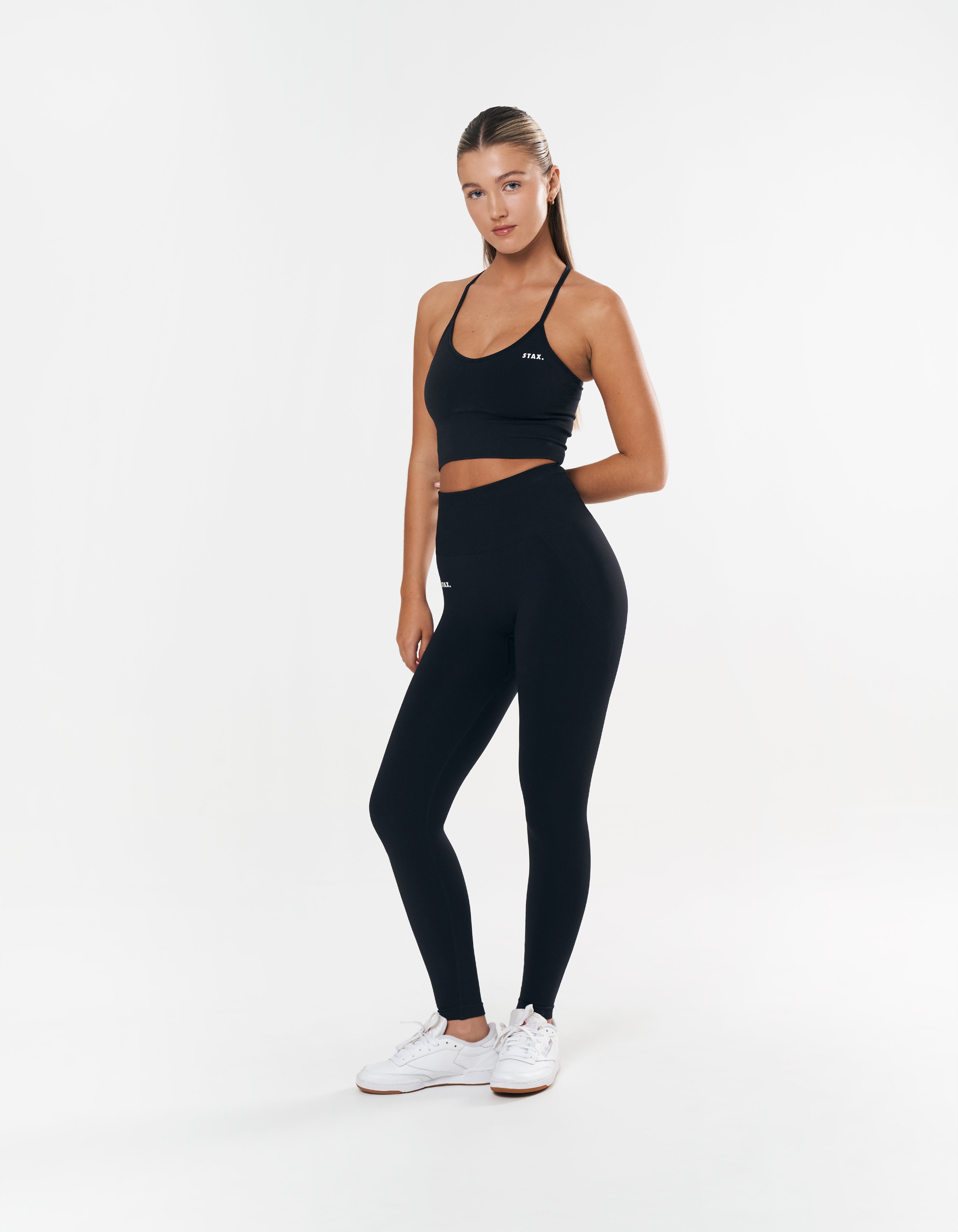 Front view of model wearing STAX. Premium Seamless Tights in Astro with matching tank top with removable padding 