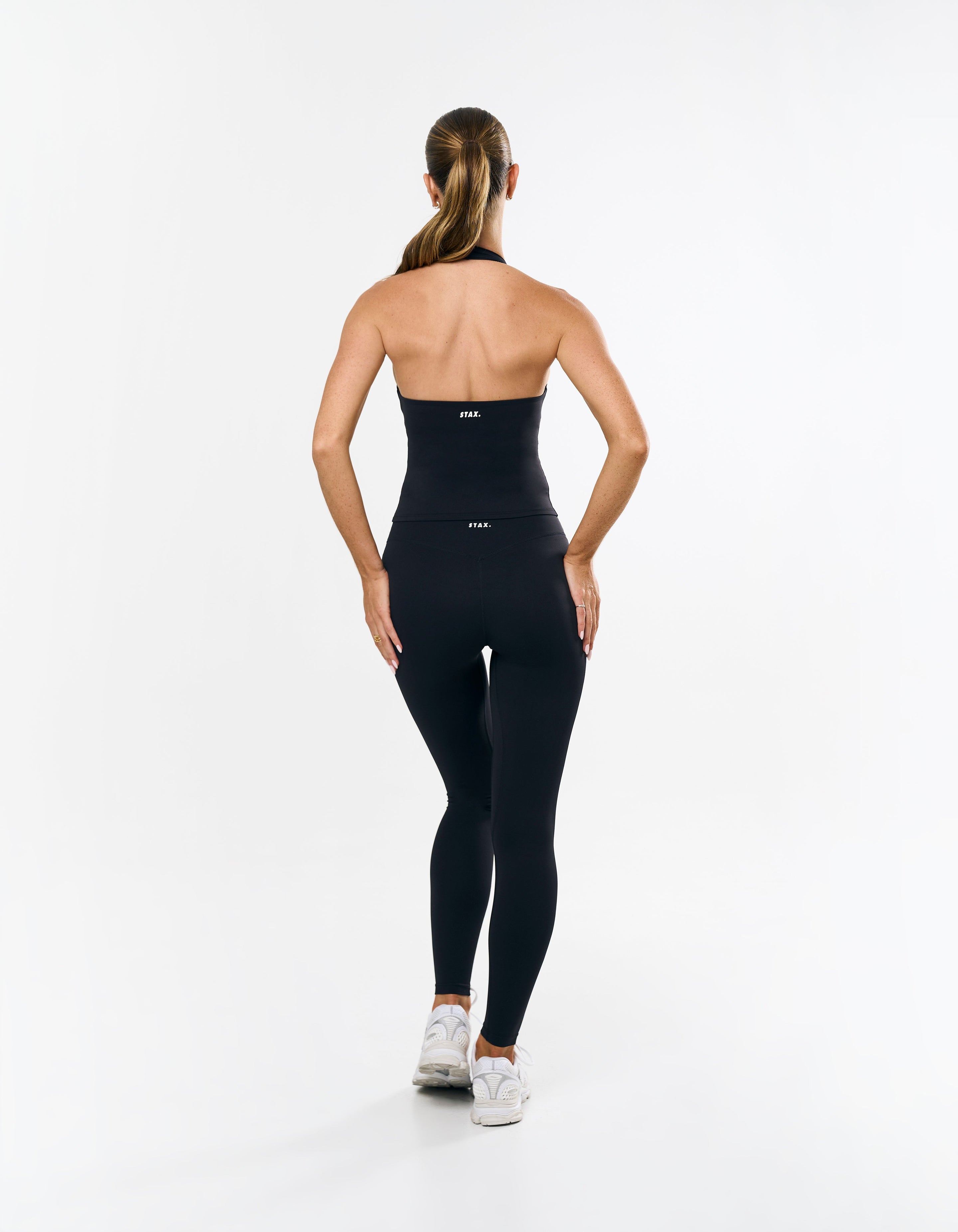 Back view of STAX. Full Length Tights Airlyte Black showing bandeau top design with white STAX. logo