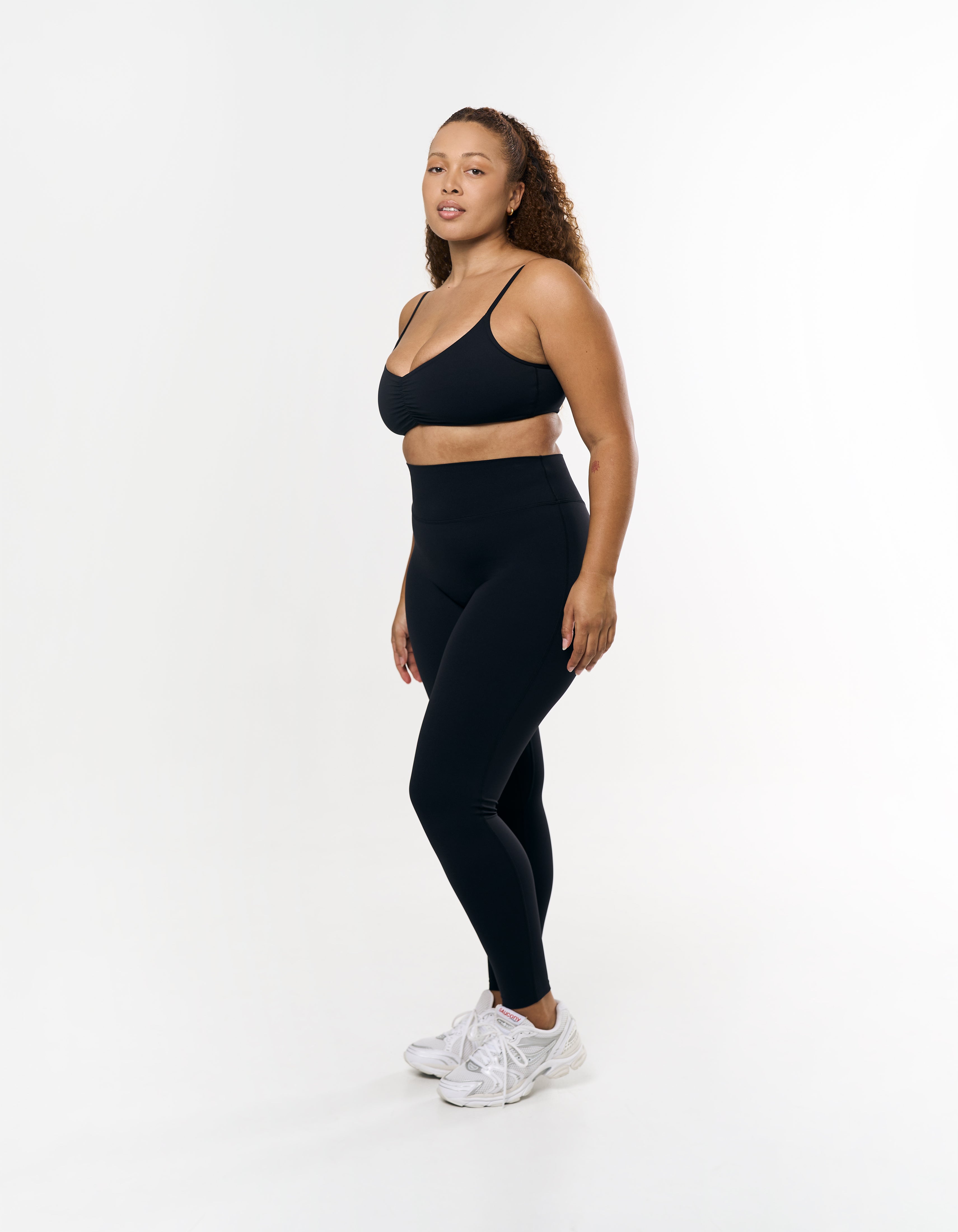 Side profile of STAX. Full Length Tights Airlyte in Black showing flatting fit