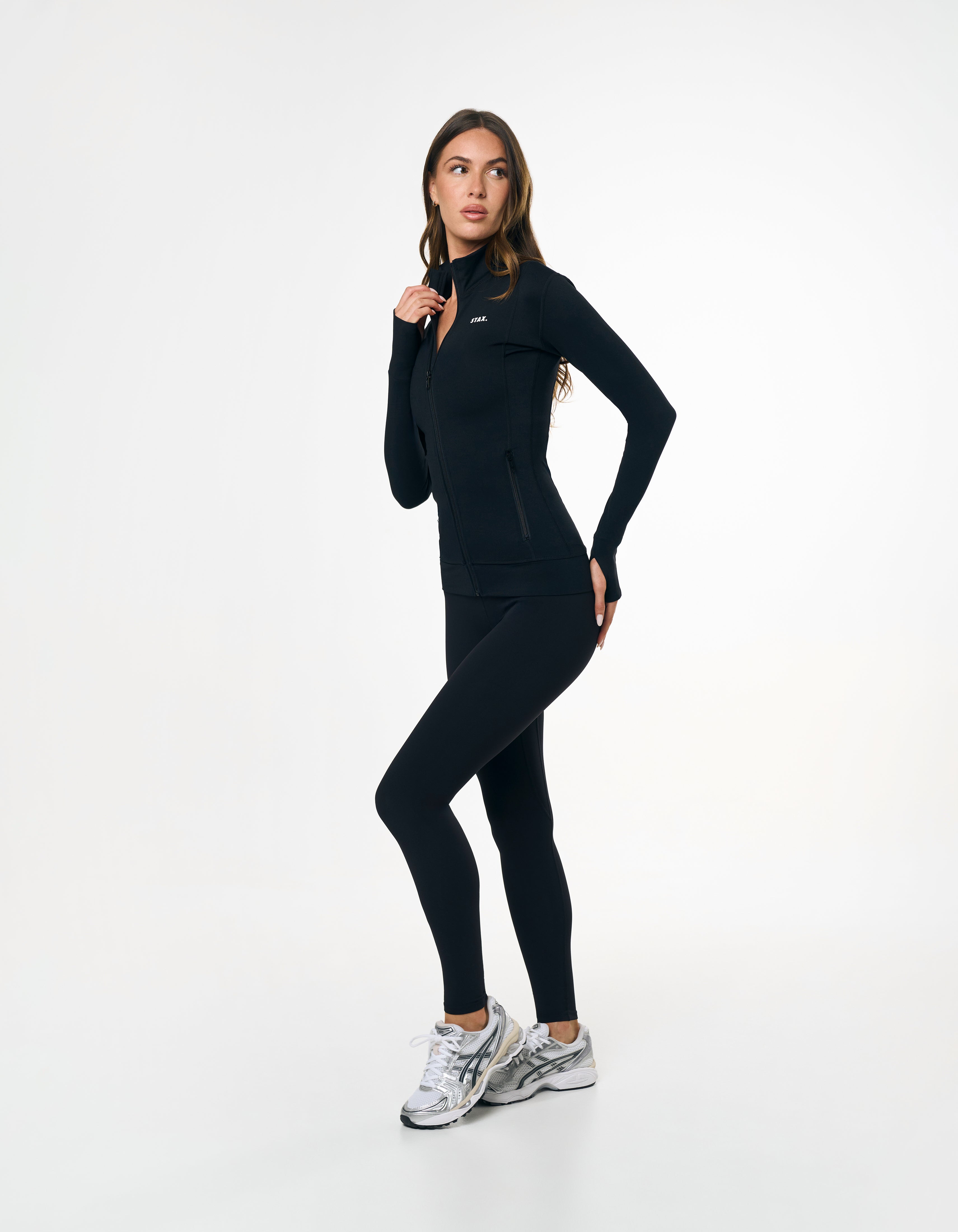 Side profile of STAX. Zip Jacket NANDEX™ in Black showing waist support to accentuate your shape  