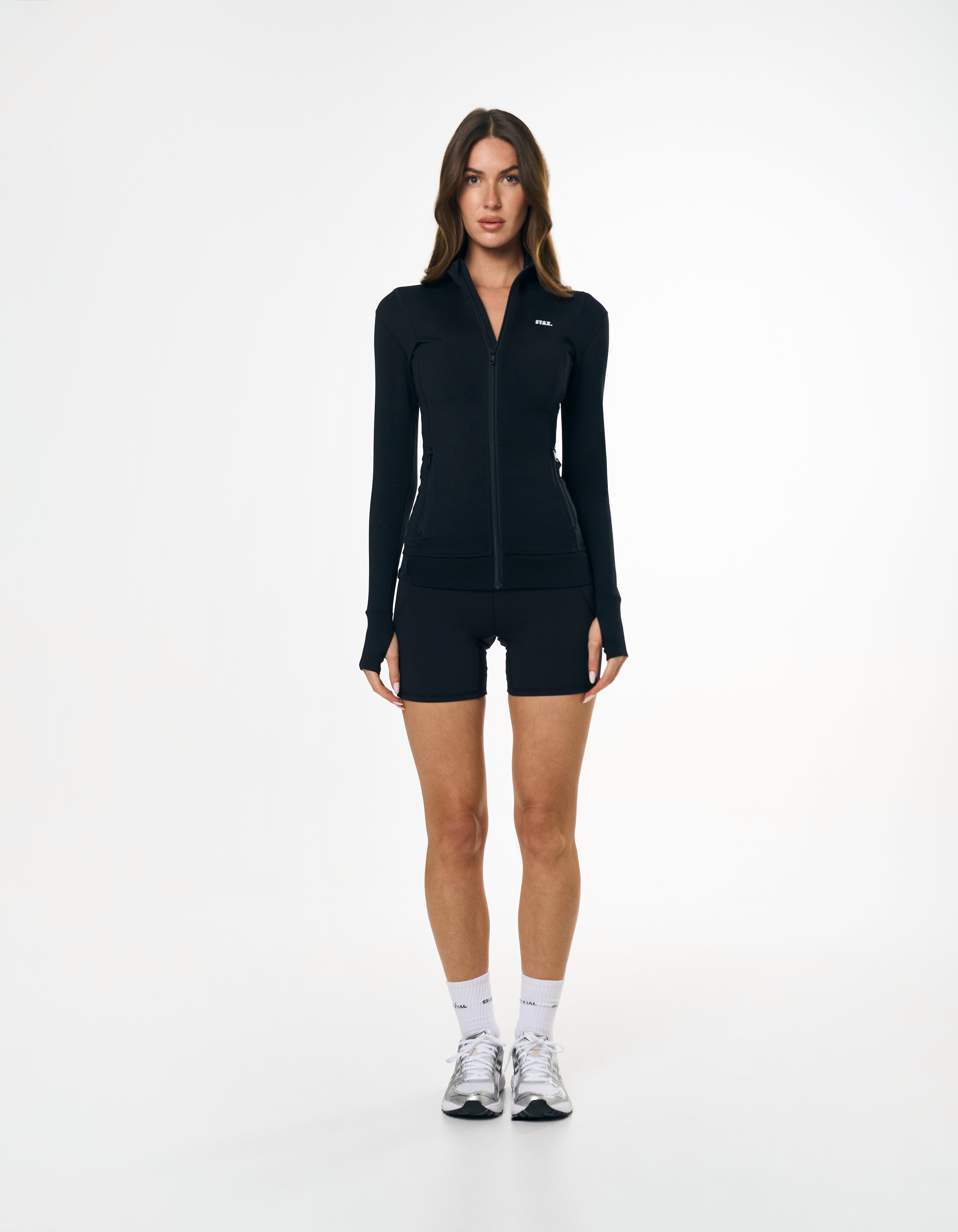 Front view of model wearing STAX. Zip Jacket NANDEX™ in Black with matching bike shorts 