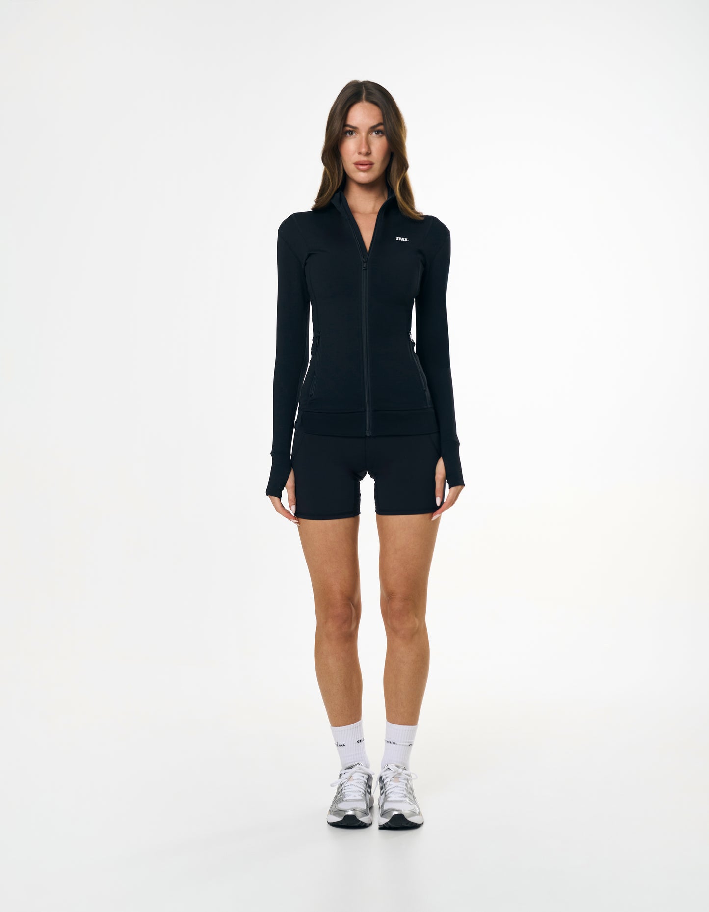 Front view of model wearing STAX. Zip Jacket NANDEX™ in Black with matching bike shorts 