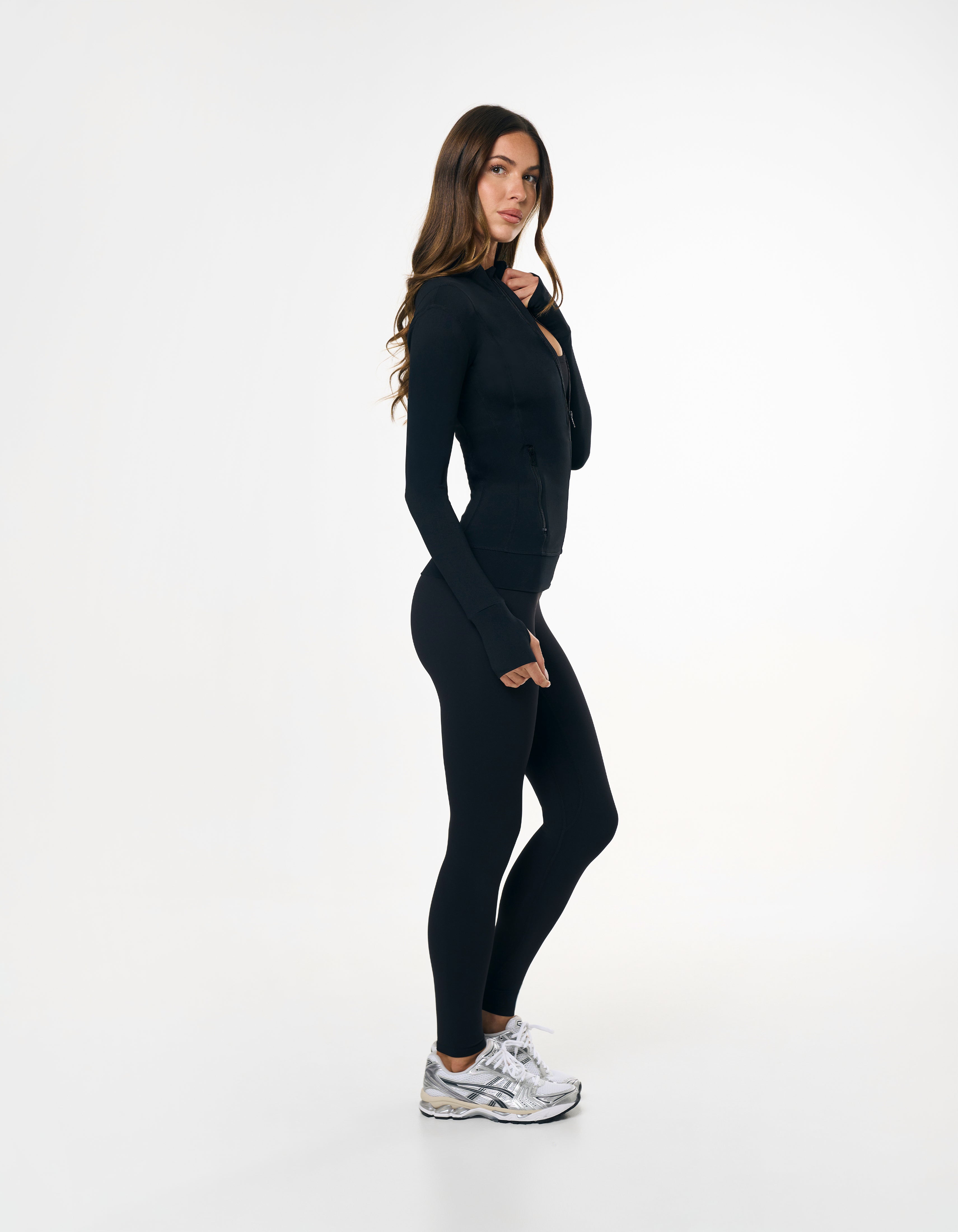 Side profile of STAX. Zip Jacket NANDEX™ in Black showing flattering tight fit
